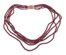 A facetted ruby bead necklace, composed of five strands of facetted ruby beads, to a pierced box