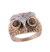 An owl ring, designed as an owl's head, with textured feathers and circular shaped labradorite to