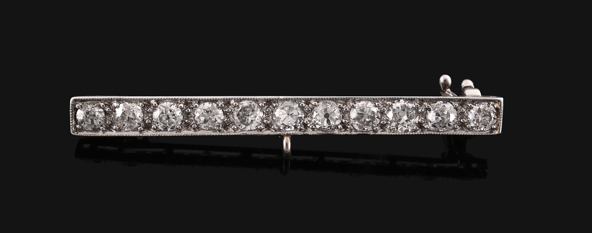 A diamond bar brooch, the bar set along the line with old brilliant cut diamonds, 4.6cm long