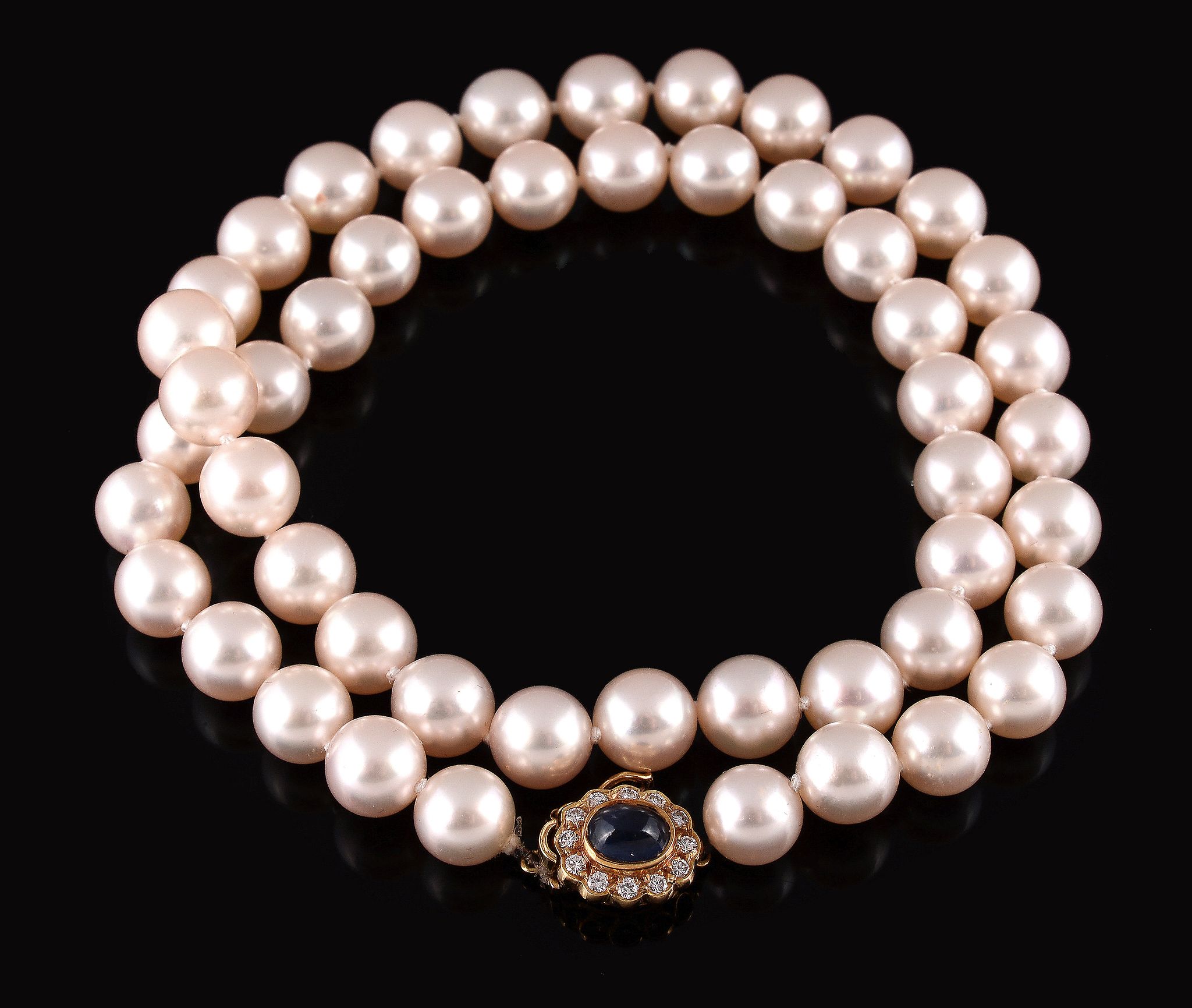 A cultured pearl necklace, the fifty uniform cultured pearls to an 18 carat gold diamond and