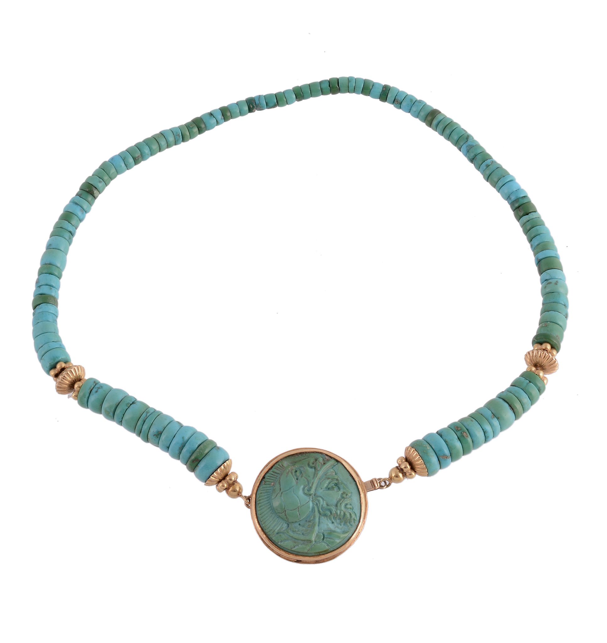 A turquoise necklace, composed of polished turquoise disc beads, the central circular panel carved