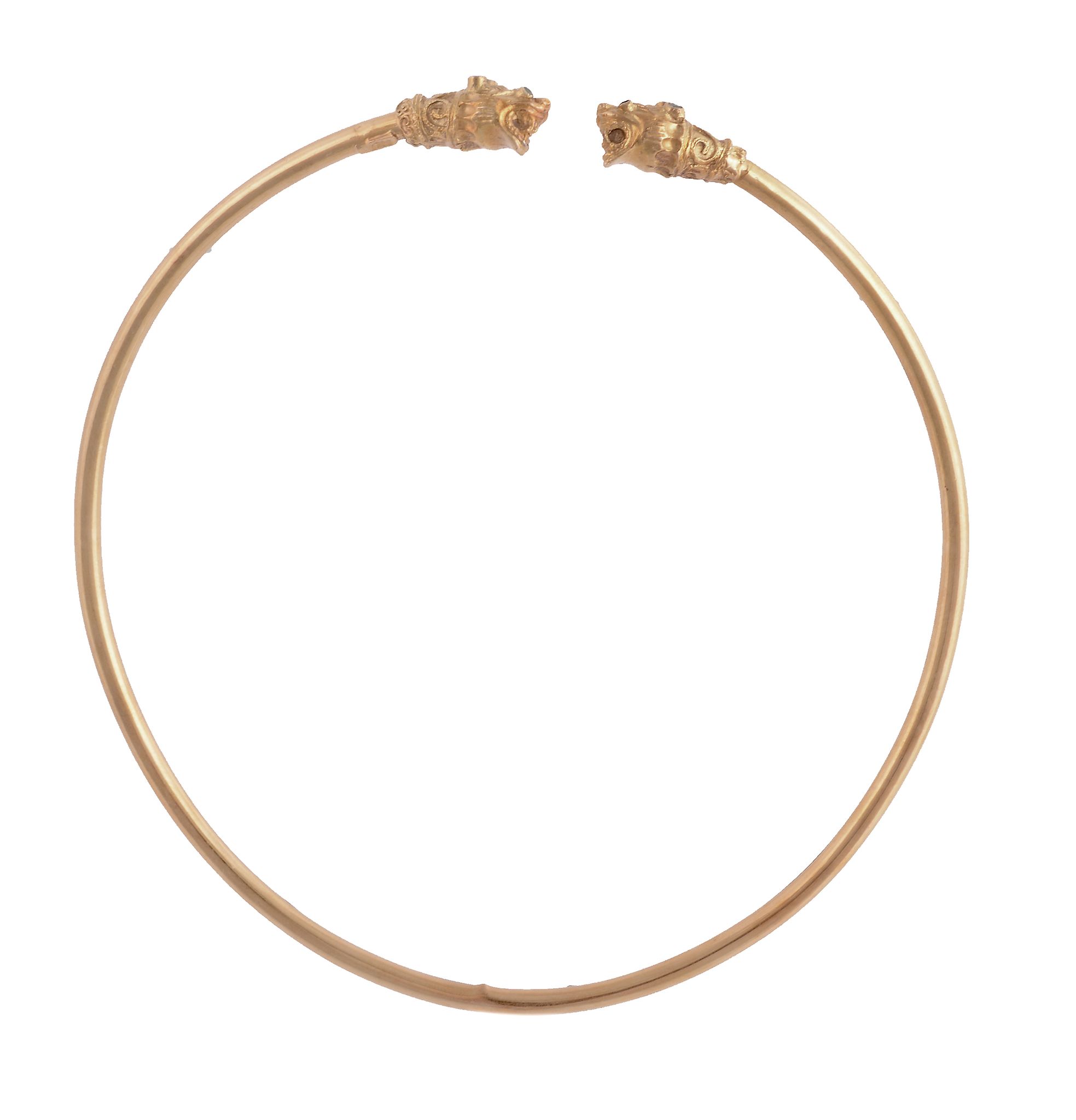 A gold torc necklace, the hollow band set with lion's head to each terminal, the eyes and head set