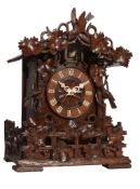 A Black Forest carved wood cuckoo table clock Attributed to Johann Baptist Beha, Eisenbach, circa