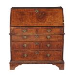 A George II walnut feather-banded bureau, circa 1750  A George II walnut feather-banded bureau,