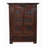 A Continental carved oak cupboard, mid 18th century  A Continental carved oak cupboard,   mid 18th