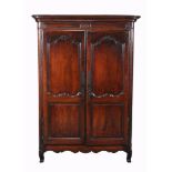 A Louis XV walnut armoire , circa 1750, the pair of arched and panelled...  A Louis XV walnut