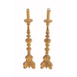 A pair of Italian carved and giltwood altar candlesticks, circa 1900  A pair of Italian carved and