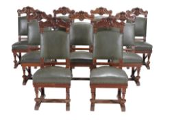 A set of eighteen carved walnut dining chairs, circa 1890  A set of eighteen carved walnut dining