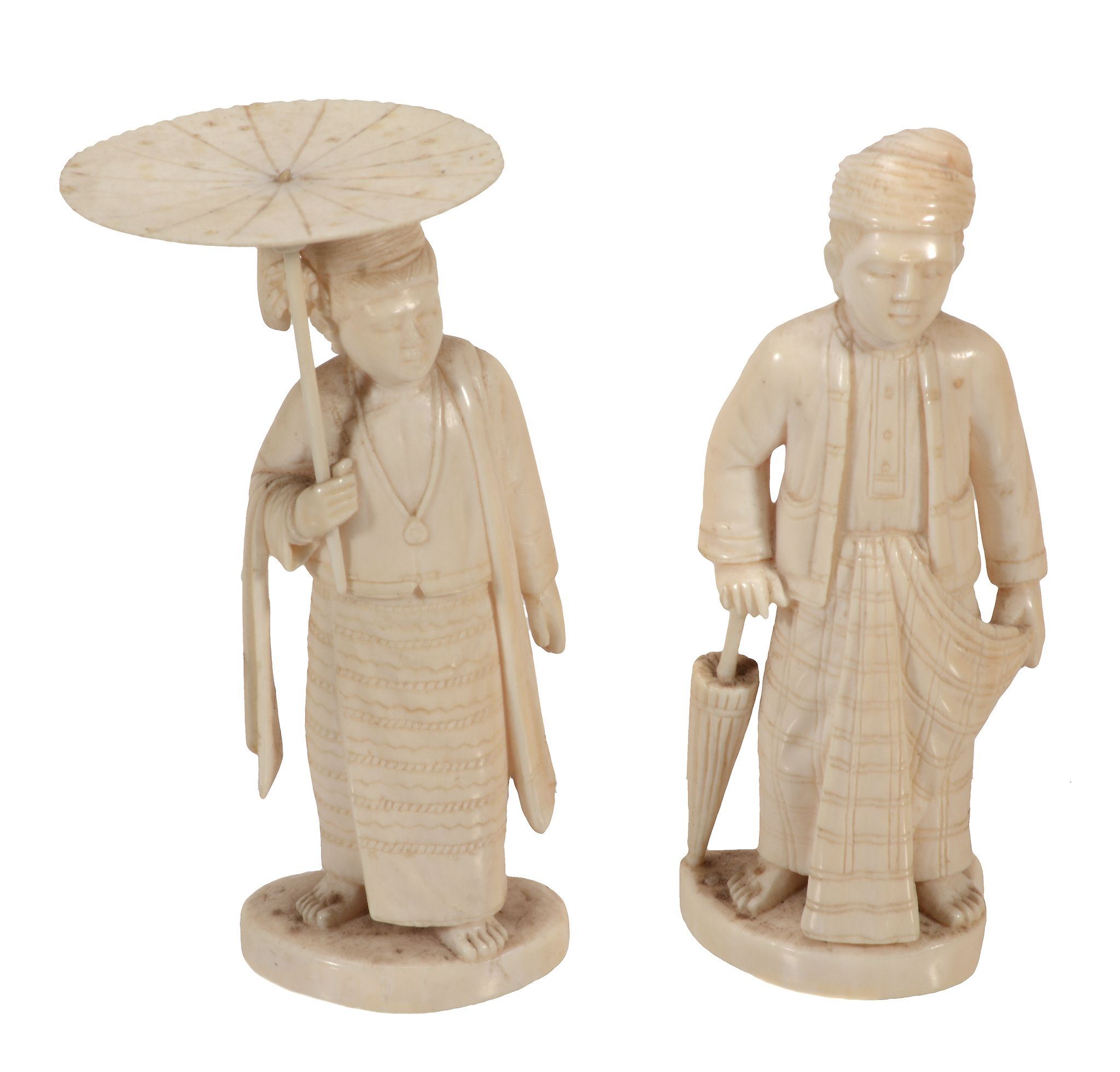 Two Indian Ivory Figures, each carved to depict a standing man dress in...  Two Indian Ivory