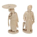 Two Indian Ivory Figures, each carved to depict a standing man dress in...  Two Indian Ivory