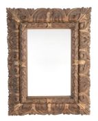 A Spanish carved and parcel giltwood framed wall mirror A Spanish carved and parcel giltwood
