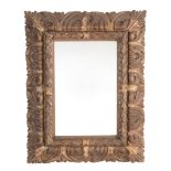 A Spanish carved and parcel giltwood framed wall mirror A Spanish carved and parcel giltwood