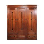 A Secessionist oak and ebony wardrobe and a matching single bedstead  A Secessionist oak and ebony