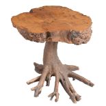 A tree table, late 20th century, with trunk cross-section top and a root...  A tree table,   late