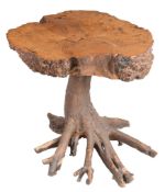 A tree table, late 20th century, with trunk cross-section top and a root...  A tree table,   late