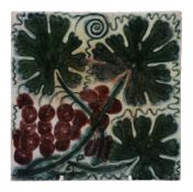 A William de Morgan 6in tile, painted with vine leaves and a bunch of grapes  A William de Morgan
