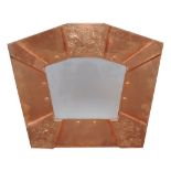 An Arts and Crafts copper wall mirror, 1920s, 76cm high, 89cm wide  An Arts and Crafts copper wall