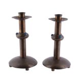 A pair of Arts and Crafts patinated brass candlesticks, circa 1910  A pair of Arts and Crafts