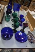 A collection of coloured glass to include blue glass wines, bowls green glass etc