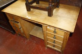A Victorian pine kneehole desk with eight short drawers 119cm wide