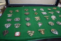 A collection of Military Cap Badges, approximately 300, contained in a black case with four hinged