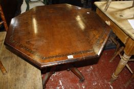 A Victorian mahogany octagonal centre table, on reeded turned pillars and four reeded sabre legs,