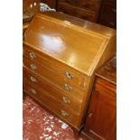 An Edwardian crossbanded mahogany bureau, the fall front with shell panel above four graduated