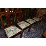 A set of four Chippendale style dining chairs with pierced splat backs, lift out seats, on