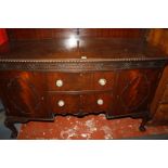 A reproduction mahogany bow front sideboard having carved gadroon decoration to the edge, carved