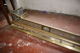 An Edwardian pierced brass fender and other pieces