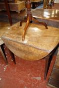 A George III mahogany oval Pembroke table, the twin-flap top above a frieze drawer, on square