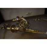 A pair of gilt metal three branch wall sconces, 81cm long approx.