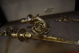 A pair of gilt metal three branch wall sconces, 81cm long approx.