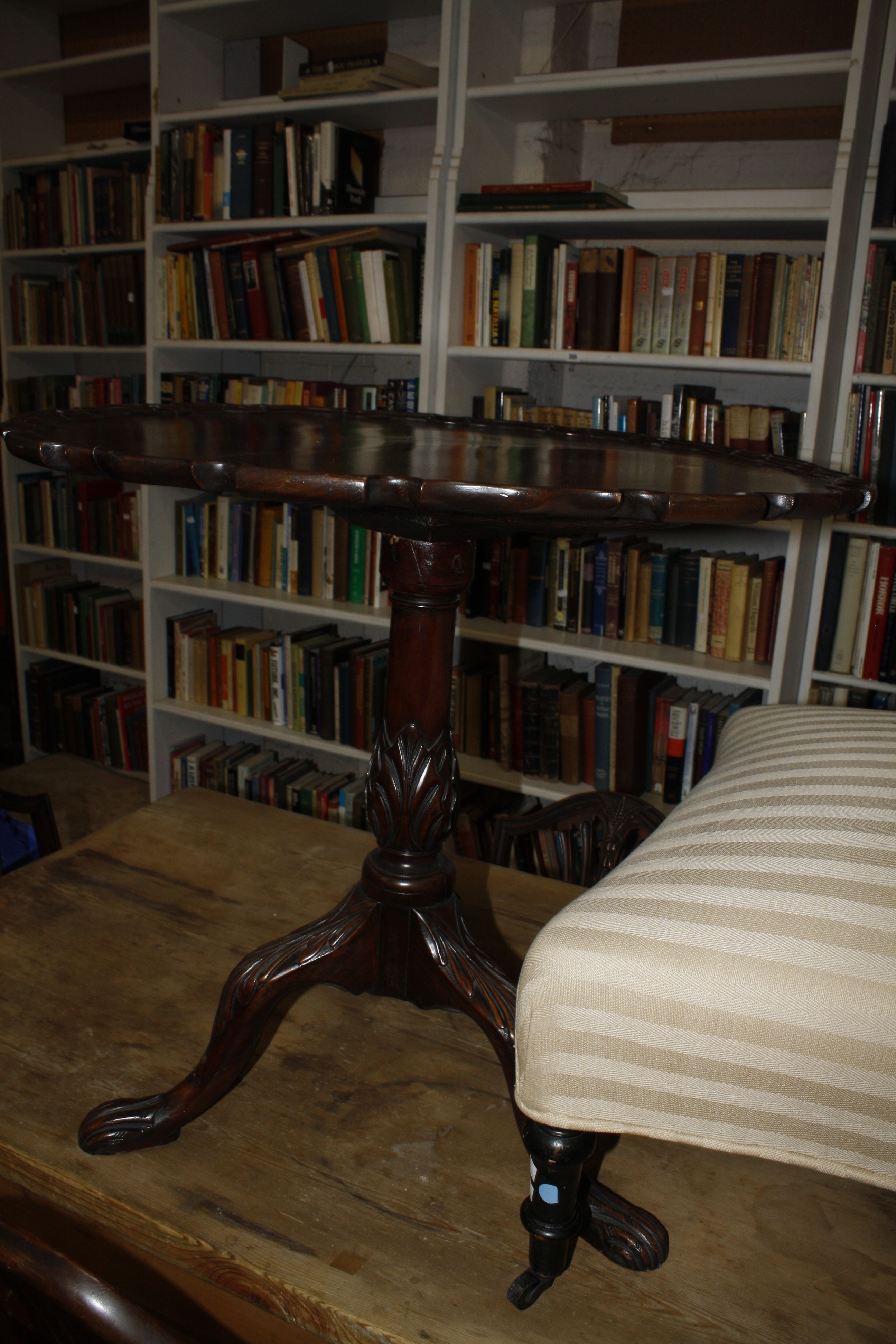 A Georgian and later mahogany pie crust tilt top table, a nest of three tables and a two tier