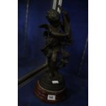 A Victorian spelter figure of a cherub on wooden plinth base, 39cm high