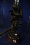 A Victorian spelter figure of a cherub on wooden plinth base, 39cm high