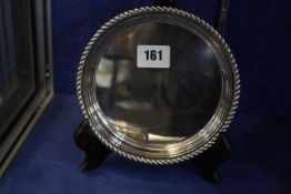 A silver salver with gadrooned border by Mappin & Webb, Birmingham 1987, 16cm diameter