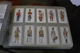 A mixed lot of ephemera to include two albums of military medals, transport, British costume, sport,