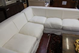 An OKA white upholstered corner settee and a pair of armchairs