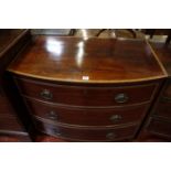 A Regency mahogany bowfront chest with three long crossbanded drawers, on splayed bracket feet, 16½