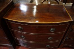 A Regency mahogany bowfront chest with three long crossbanded drawers, on splayed bracket feet, 16½