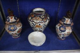 A pair of Japanese export Imari vases with covers and a larger example (lacking cover) and a