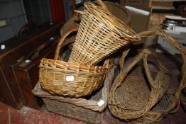 Assorted wicker baskets and two vintage leather suitcases Best Bid