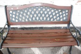 A cast iron and slatted garden bench