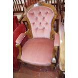 A Victorian walnut button back upholstered armchair.