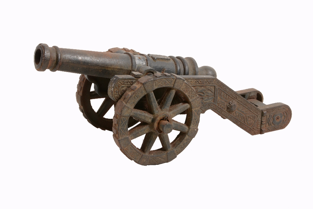 A cast iron model of a canon, late 19th / early 20th century, the knopped barrel cast in relief with