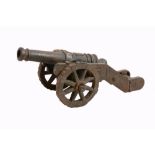 A cast iron model of a canon, late 19th / early 20th century, the knopped barrel cast in relief with