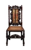 An 18th century carved walnut Caroleon chair with a caned seat