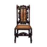 An 18th century carved walnut Caroleon chair with a caned seat