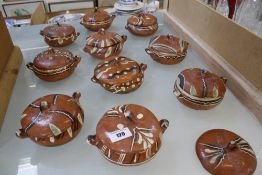 Ten Mexican terracotta lidded pots (one extra lid)